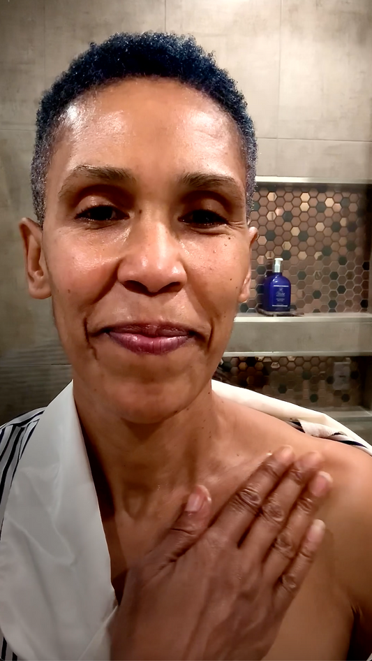 Woman moisturizing shoulder | Violet Botanical Skincare