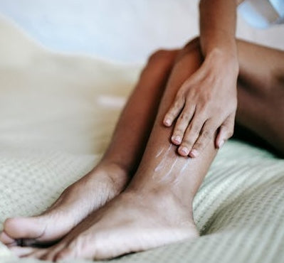 Woman massaging lower leg